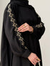 Lower pleat detail and fluid bottom hemline drape of black Haya Abaya