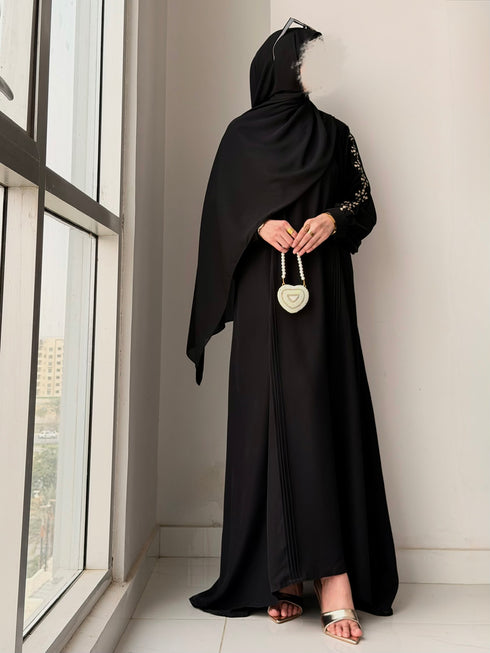 Side view showing graceful flare and front pleats design of Haya Abaya
